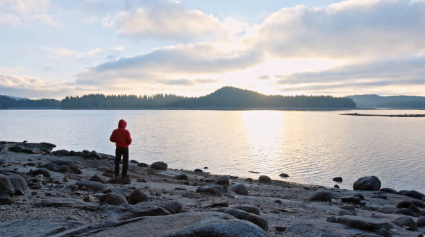 istock Man relaxing in nature at sunset. Getting away from it all. 1369224010