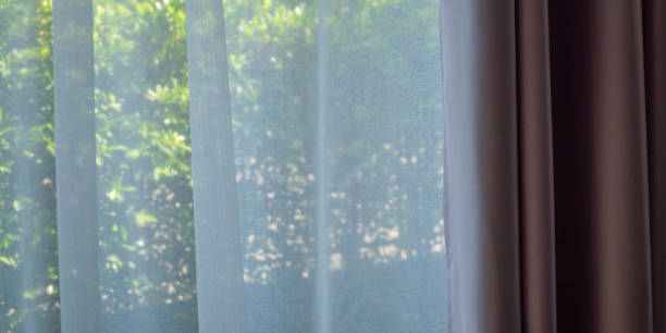 istock Close up curtain window with green garden background 1369224031