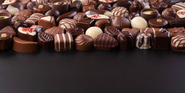 istock chocolate candy on black background, delicious treat for snack 1369226180