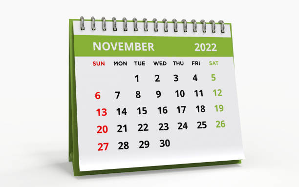 Standing Desk Calendar November 2022 green Standing Desk Calendar November 2022. Business monthly calendar with metal spiral-bound, the week starts on Sunday. Monthly Pages on a white base and green title, isolated on a white background, 3d render. november stock pictures, royalty-free photos & images