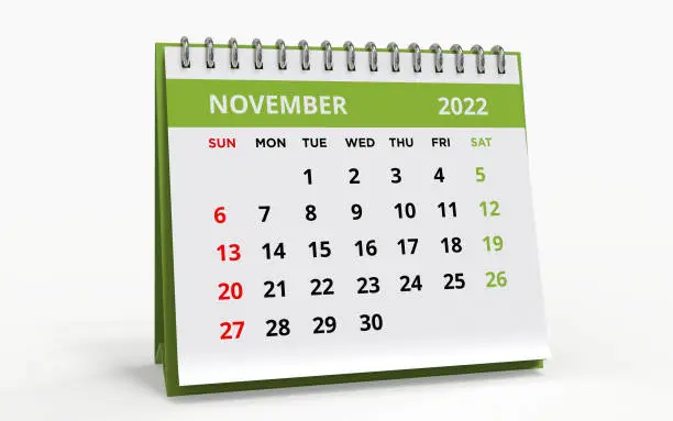 Standing Desk Calendar November 2022. Business monthly calendar with metal spiral-bound, the week starts on Sunday. Monthly Pages on a white base and green title, isolated on a white background, 3d render.