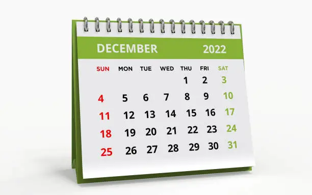 Standing Desk Calendar December 2022. Business monthly calendar with metal spiral-bound, the week starts on Sunday. Monthly Pages on a white base and green title, isolated on a white background, 3d render.