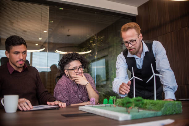 istock Businesspeople talking about renewable energy 1369232409