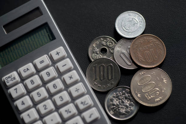 Calculators and Japanese pennies. Images of low wages and low hourly wages.