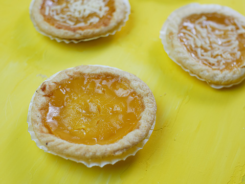 Pineapple and cheese flavored pie on orange background.