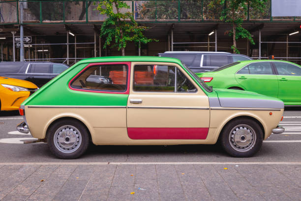 Multi-colored older car on a Manhattan street