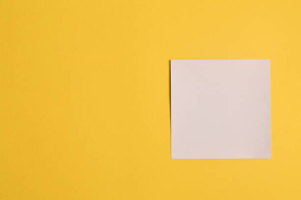 istock Memo note isolated on yellow background. Copy space for the text. 1369234253
