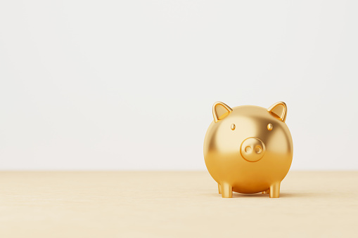 Save money and investment concept. Gold piggy bank on wood table. 3d rendering illustration