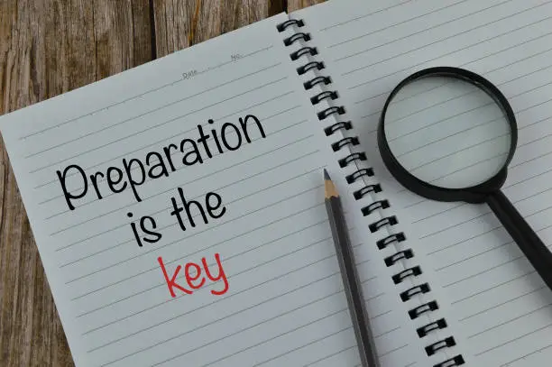 Photo of Notebook written with text PREPARATION IS THE KEY