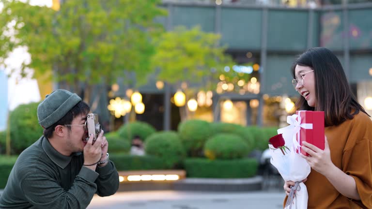 Hipster man taking photos with girlfriend on happy time.