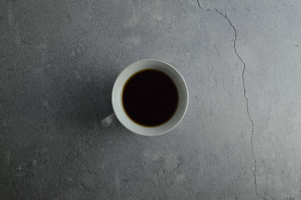 istock Top view of a cup of coffee over grey background 1369241676