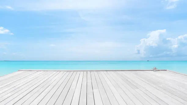 Photo of Wooden jetty on turquoise sea with clear sky background