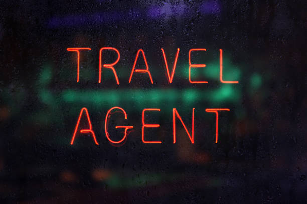 istock Neon Travel Agent Sign in Rainy Window 1369244593