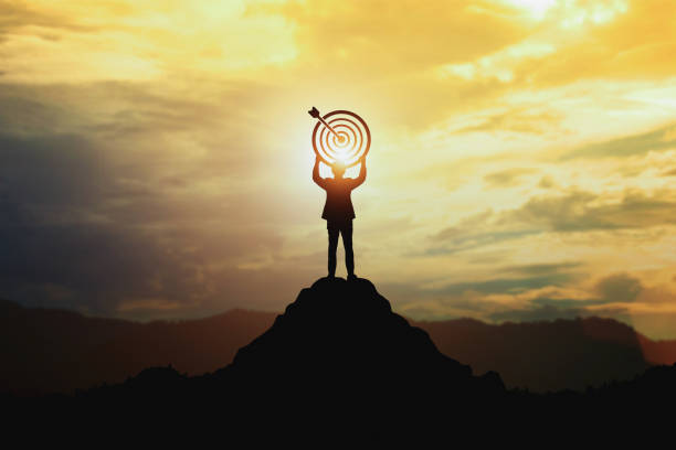 Silhouette of businessman holding a target board stock photo