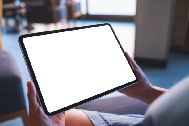 Mockup image of a woman holding digital tablet with blank white desktop screen in cafe stock photo