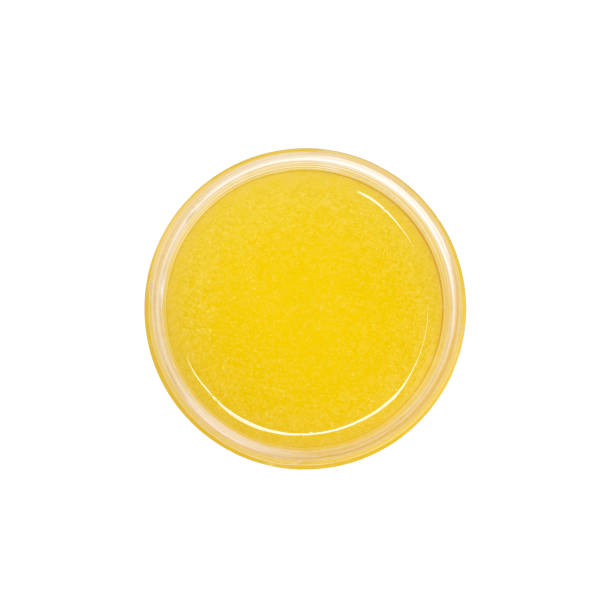 istock Yellow shower gel scrub container isolated on white background from top view. Sugaring. 1369248404