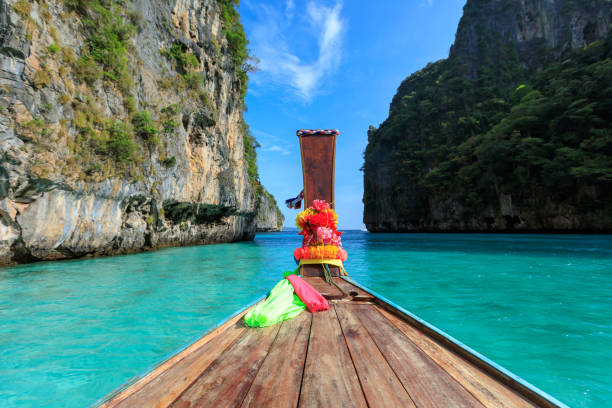 istock head long tail boat on the sea and cliff rock mountain background 1369250666