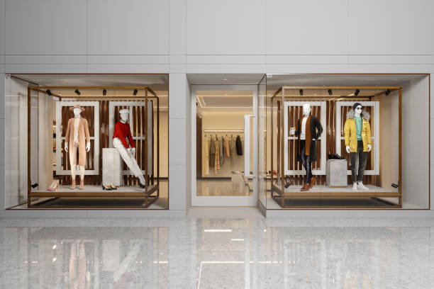 Exterior Of Clothing Store With Women's And Men's Clothing On Mannequins Displaying In Showcase. Exterior Of Clothing Store With Women's And Men's Clothing On Mannequins Displaying In Showcase. clothing store stock pictures, royalty-free photos & images