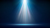istock Spotlight background. Illuminated blue stage. Backdrop for displaying products. Bright beams of spotlights, shimmering glittering particles, a spot of light. Vector illustration 1369254056