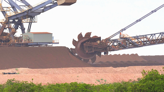 close up of an iron ore bucket wheel reclaimer in operation at port hedland in western australia