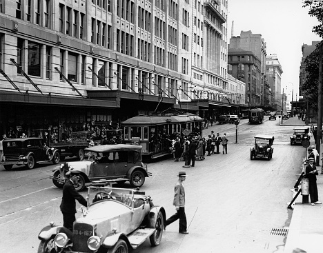 Historical Elizabeth street Sydney from Market st looking north with cars and trams, 1931