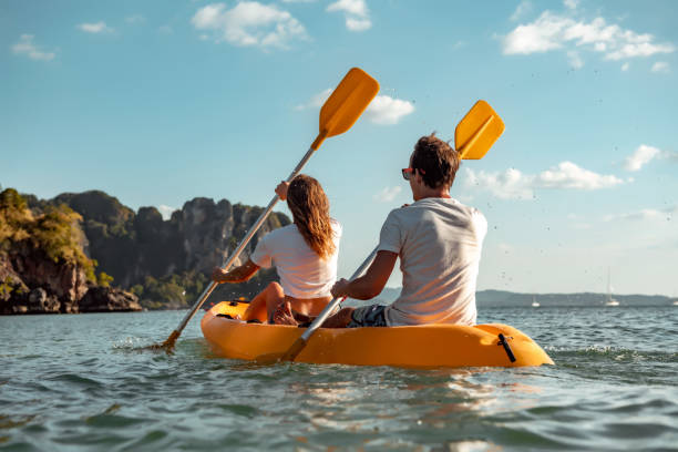 sea kayaking at tropical bay. summer vacations - caiaque imagens e fotografias de stock