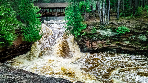 istock Heavy water moves under the bridge and into the pool below. 1369257436