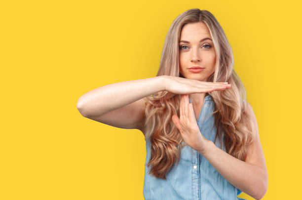 istock Young caucasian woman over isolated background making time out gesture. 1369260274