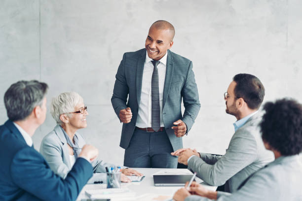 istock Mature businessman leading a meeting 1369260276