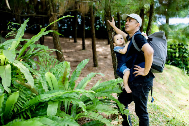 istock man playing with her baby on the public park 1369260327