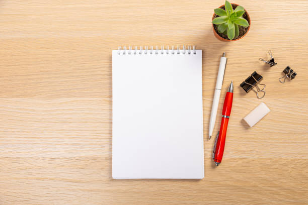 istock Working table with keyboard and notepad, pen, pencil and plant in home office. top view 1369260653