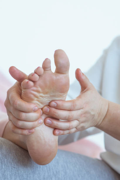 istock Hands making thai feet massage. Alternative medicine and thai massage concept 1369262019