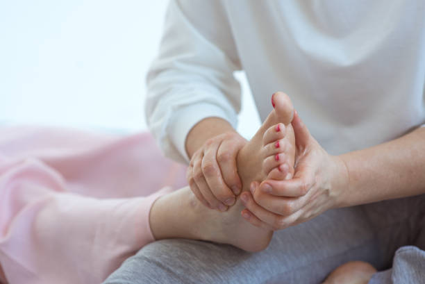 istock Hands making thai feet massage. Alternative medicine and thai massage concept 1369262169