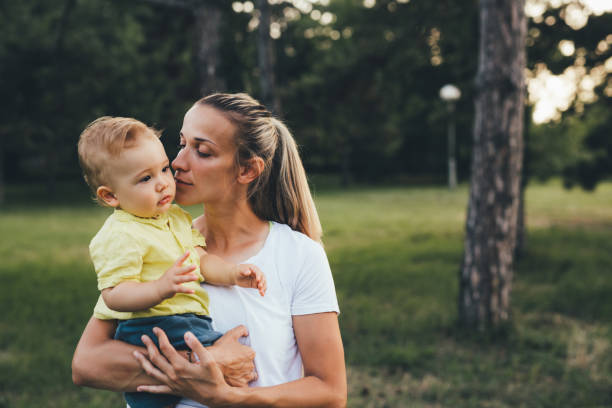 istock mother exercise with her son in public park 1369264615