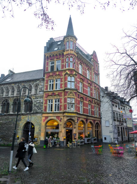 grashaus entrance gate with old archway and inscription under the ledge. the building on the fischmarkt in aachen, known as the grashaus. - aachen brick building exterior built structure imagens e fotografias de stock