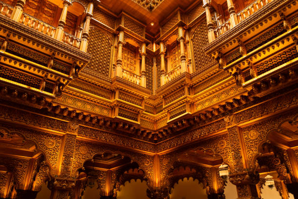 Wall and ceiling at an Indian temple with wooden structure and golden color pattern. Religious feeling.