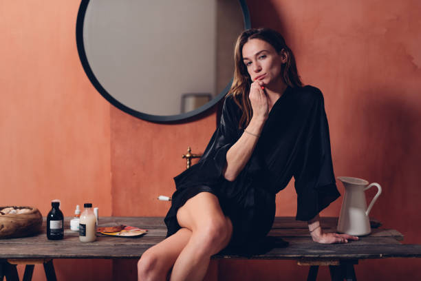 Young woman brushes her teeth before going to sleep
