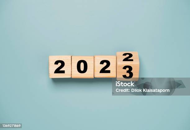 Wooden Block Cube Flipping Between 2022 To 2023 For Change And Preparation Merry Christmas And Happy New Year Stock Photo - Download Image Now