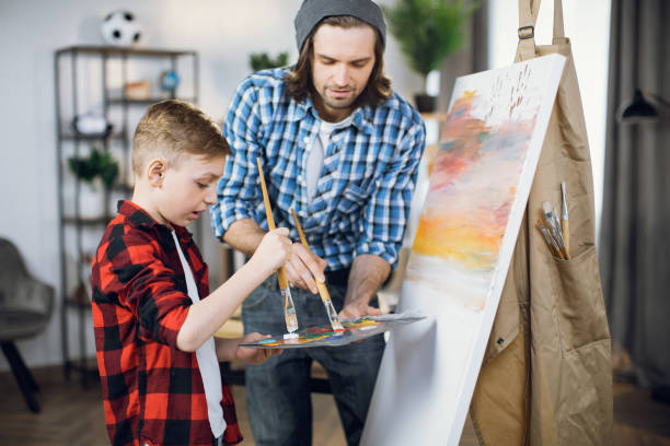 istock Father spending time with son for painting on easel 1369272272