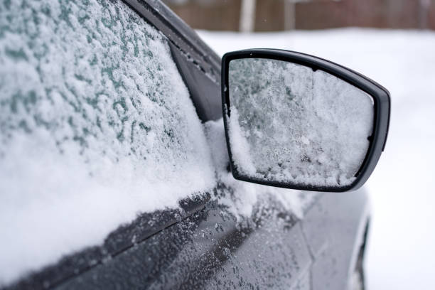 istock car side mirror and side passenger glass in snow 1369273131
