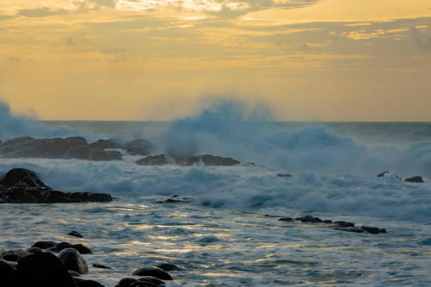 istock heavy wave on rocky beach due to tropical cyclone Batsirai. 1369273590
