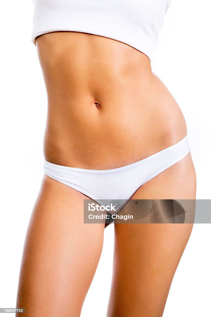 Woman's body. Slim tanned woman's body. Isolated over white background. Women Stock Photo