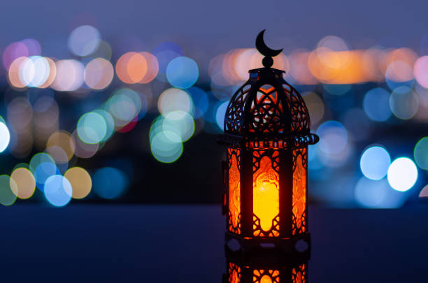 istock Lantern that have moon symbol on top with city bokeh light background 1369277540