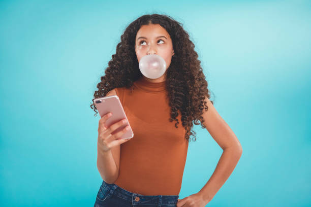 Beautiful teenager blowing bubbles