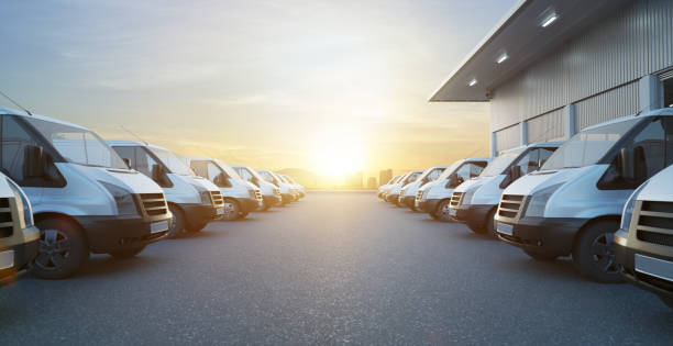 istock Commercial vans in two row with empty floor and factory building behide 1369278872