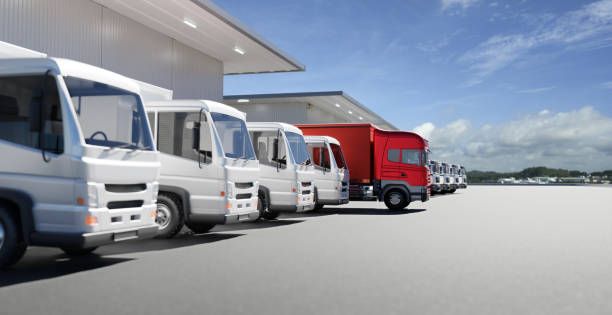 several trucks lined up in front of a warehouse