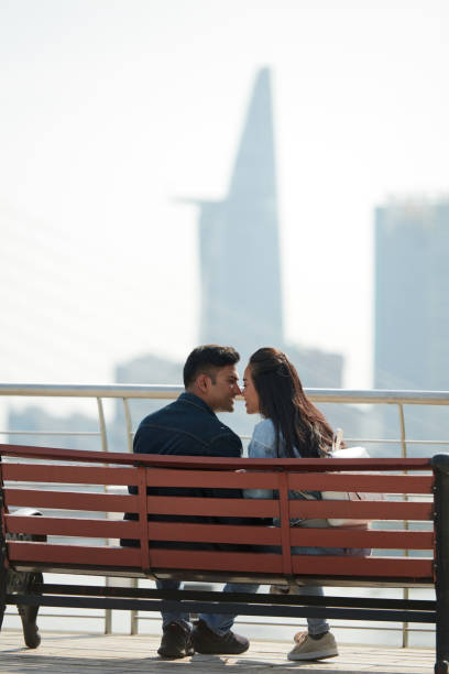 istock Couple Kissing on Bench 1369279097