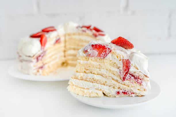 istock Delicious cake with cream cheese and strawberries. Beautiful serving on a white brick background 1369279727