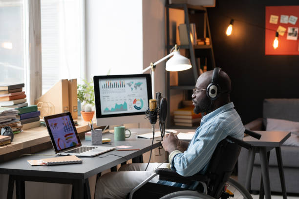 istock Man with disability sitting at conference 1369280129
