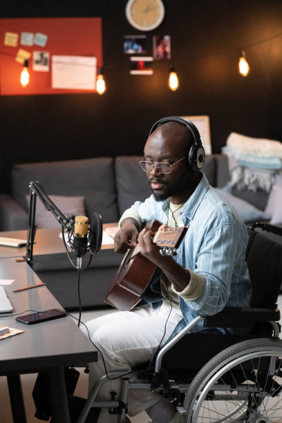 istock Man recording his music at home 1369280199